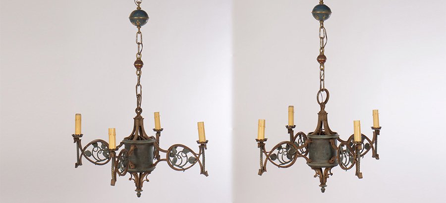 PR WROUGHT IRON BRONZE CHANDLIERS 4 ARMS 1920: A pair of Art Nouveau wrought iron and bronze chandeliers, each having four arms with stylized foliate decoration circa 1920. Width: 31" Depth: 31"