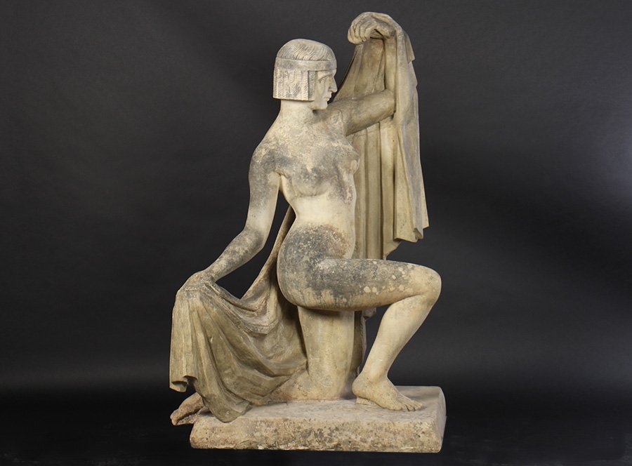 RARE SIGNED LIFESIZE CARVED LIMESTONE FIGURE 1920: A fine and rare French signed 'M. Esders' Art Deco life sized carved limestone figure of a female with draped cloth and elegant form circa 1920. All raised on platform base. Ht: 59" Width: 33" Depth:
