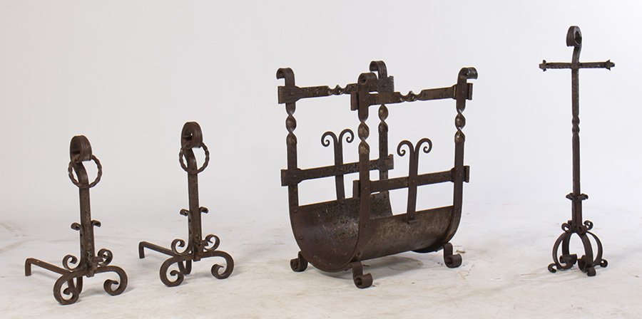 4 PC LOT WROUGHT IRON FIREPLACE EQUIPMENT 1915: A four piece lot of Arts & Crafts hand wrought iron fireplace equipment including log holder, pair of andirons, and a tool holder circa 1915.
