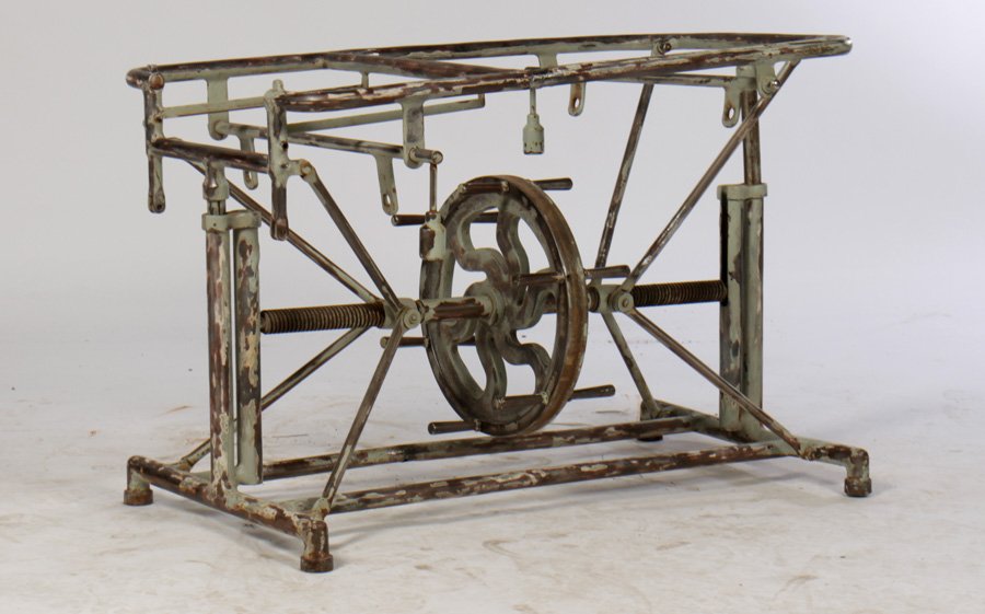 INDUSTRIAL METAL MECHANICAL TABLE BASE 1920: An industrial metal mechanical table base having central spoke wheel for height adjustment circa 1920. Remnants of paint decoration. Ht: 28" Width: 37" Depth: 20"
