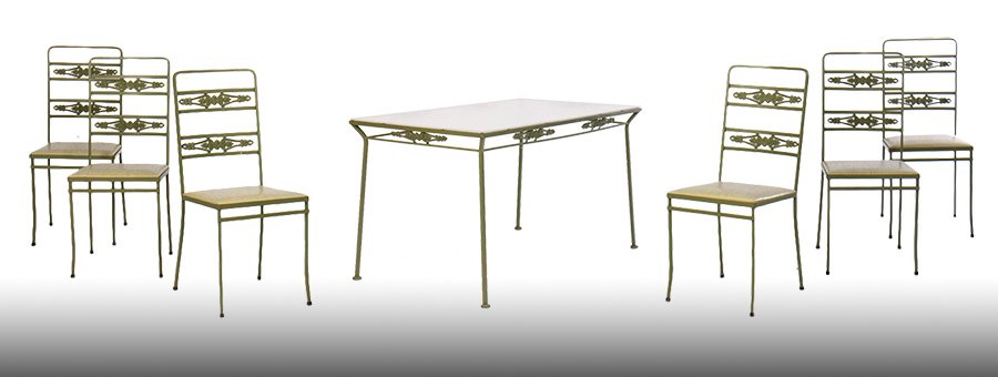 7 PC WROUGHT IRON PATIO SET 6 CHAIRS TABLE 1960: A seven piece vintage wrought iron patio set having glass top over cast aluminum decorated apron together with six side chairs circa 1960. Ht: 29.5" Width: 54" Depth: 30"