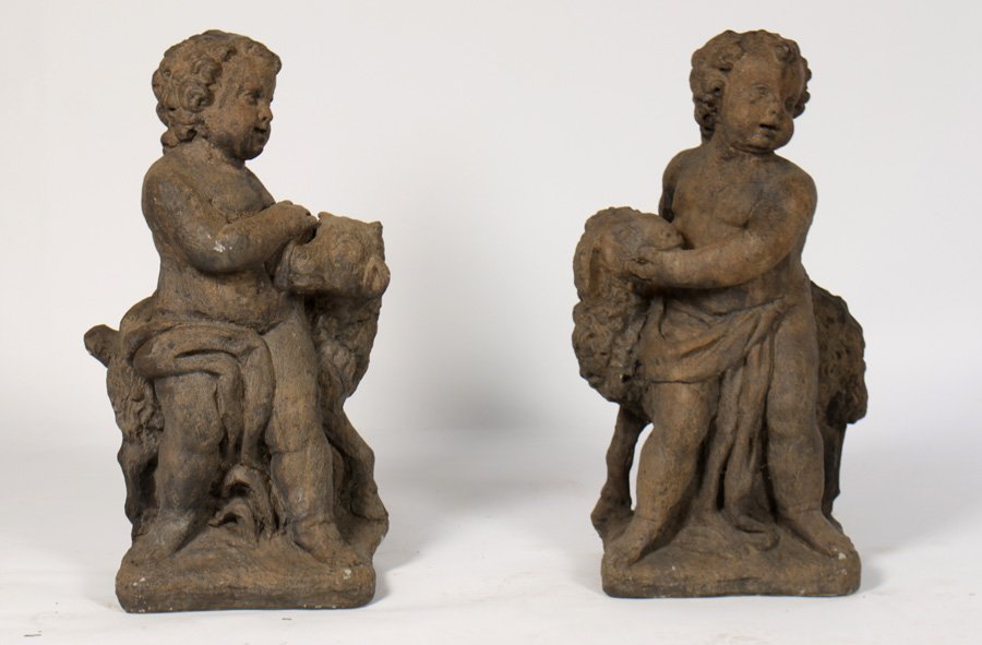 PAIR CAST STONE PUTTI CURLY COATED SHEEP: A pair of cast stone putti and curly coated sheep standing on naturalistic raised base. Ht: 34" Width: 12" Depth: 14"