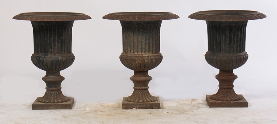 SET 3 CAST IRON CAMPANA FORM GARDEN URNS: A set of 3 cast iron campana form garden urns having egg and dart rim over fluted body and raised on stepped base. Provenance: Removed from a Main Line, PA estate. Ht: 27" Dia: 20"