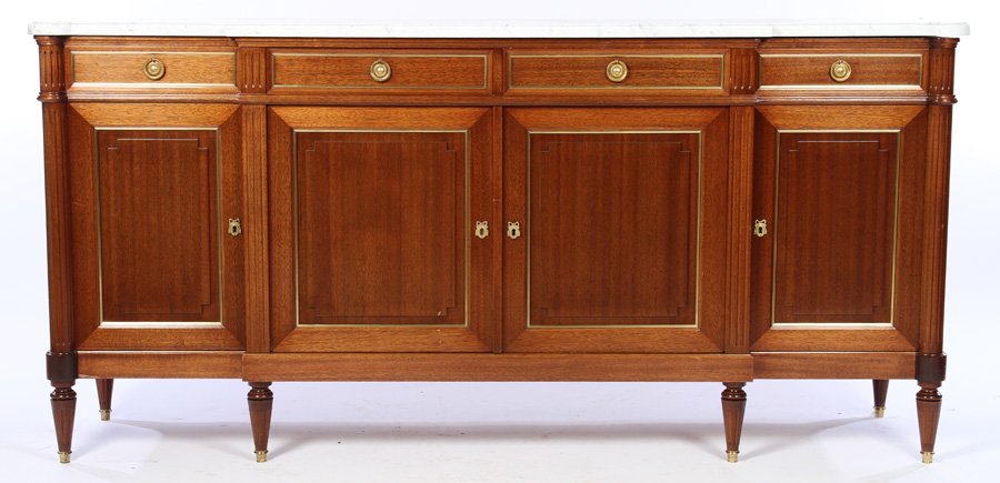 MAHOGANY BRONZE MOUNTED MARBLE TOP SIDEBOARD 1950: A mahogany and bronze mounted marble top sideboard in the Directoire style circa 1950. The case having four doors and four drawers, resting on turned and fluted legs. Ht: 41" Width: 83" Depth: 22"