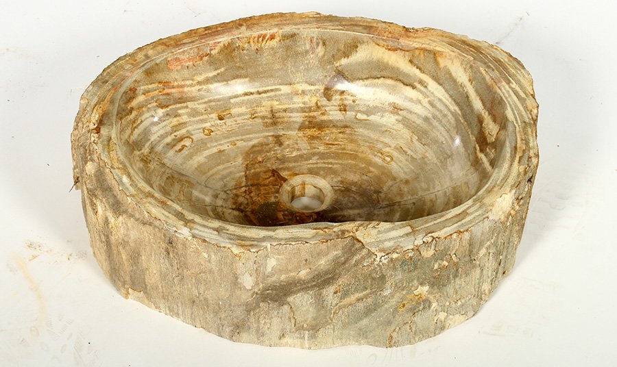 PETRIFIED WOOD CARVED BOWL FORM SINK NATURAL BARK: A petrified wood carved bowl form sink with natural bark exterior. Ht: 6" Width: 21" Depth: 16"