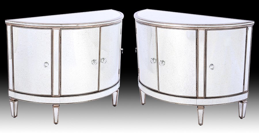 PAIR MIRRORED DEMILUNE COMMODES 4 CURVED DOORS: A pair of mirrored demilune commodes having beveled top over four curved doors and raised on tapered legs. Ht: 30" Width: 42" Depth: 18"