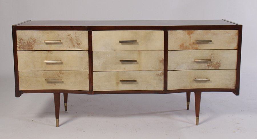 ITALIAN CURVED FRONT PARCHMENT CREDENZA C.1960: An Italian curved front credenza having nine parchment front drawers all raised on turned legs circa 1960. Ht: 28.5" Width: 61" Depth: 18"