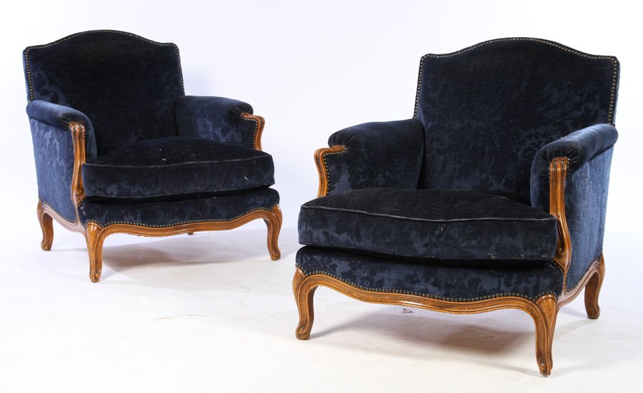 PAIR WALNUT LOUIS XV BERGERE CHAIRS 1930: A pair of walnut Louis XV style upholstered bergere chairs having a loose cushion upholstered seat circa 1930. Ensuite with the preceding lot. Dimensions: Ht: 32" Width: 28" Depth: 30" Seat Height: 13