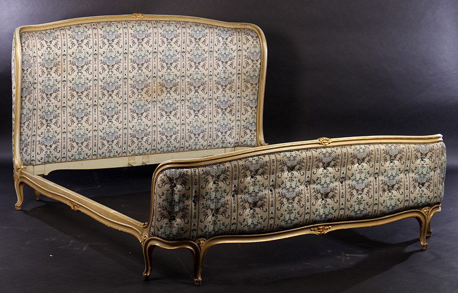 KING SIZE LOUIS XV CARVED PAINTED BED 1940: A king sized Louis XV style carved and painted bed having giltwood accents framing upholstered headboard and footboard circa 1940. Ht: 47" Width: 47"