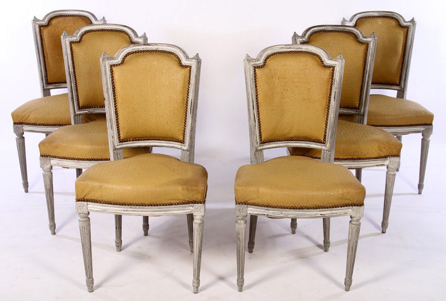 SET OF 6 FRENCH CARVED PAINTED DINING CHAIRS 1950: A set of six French carved and painted dining chairs having nail head decorated backs and seats all raised on turned and fluted legs circa 1950. Ht: 36" Width: 20" Depth: 21"