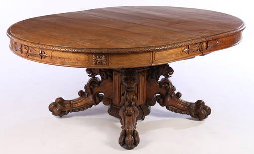 18' + VICT. DINING TABLE DANIEL PABST ARTISTIC HOUSES: A rare and important American Victorian lion head pedestal oak dining table attributed to Daniel Pabst circa 1870. The solid quartersawn oak top having a carved edge. Ht: 30" Width: 71" Depth: 54" The