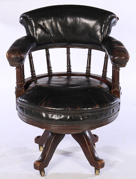 LEATHER UPHOLSTERED REVOLVING OFFICE CHAIR 1900: A good leather upholstered revolving office chair having turned baluster supported back over curved seat supported on revolving base circa 1900. Seat height: 19" Ht: 34.5" Width: 26" Depth: 26"