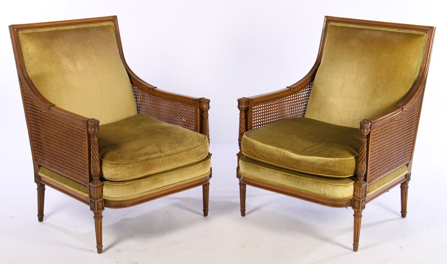 PAIR LOUIS XVI BERGERE CHAIRS LOOSE CUSHION SEAT: A pair of Louis XVI style bergere chairs having downswept arms, caned sides, and loose cushion seat raised on turned and fluted legs. Seat height: 18" Ht: 38" Width: 29" Depth: 24"
