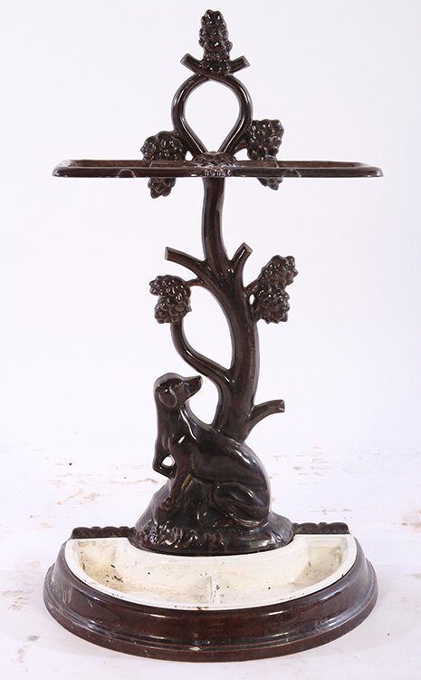 CAST IRON CANE UMBRELLA HOLDER COLEBROOKDALE: Interesting enameled cast iron cane or umbrella holder having stylized tree and seated dog design in the manner of Colebrookdale. Ht: 27" Width: 14.5" Depth: 9"