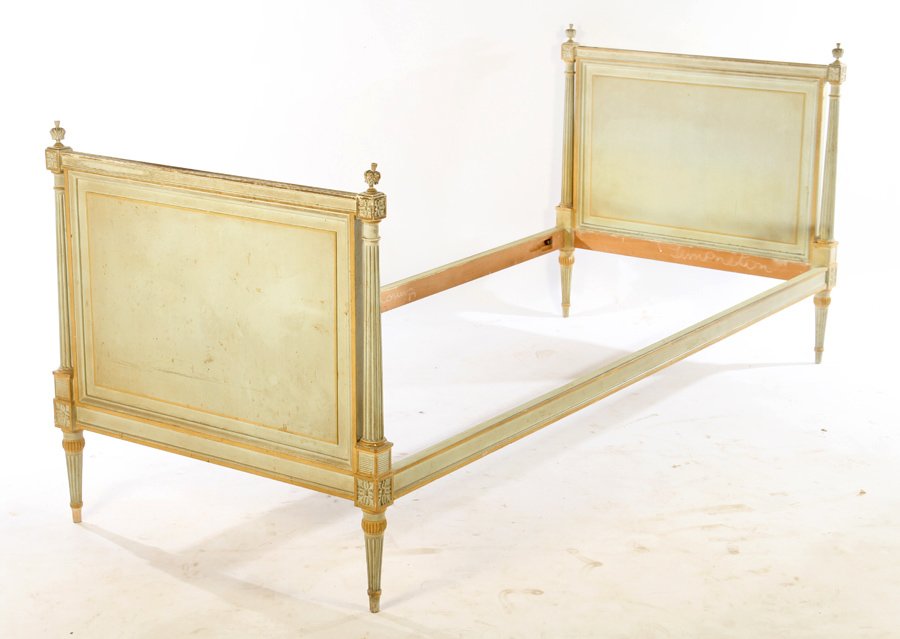 LOUIS XVI CARVED PAINTED DAYBED 1940: A Louis XVI style carved and painted daybed having finial decoration over fluted columns circa 1940. Ht: 34" Width: 78" Depth: 34"