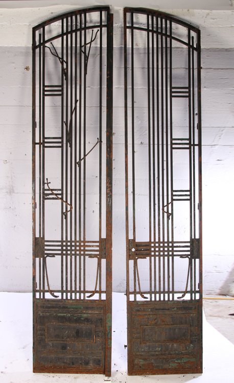 LARGE PAIR ART DECO WROUGHT IRON DOORS GATES: A monumental pair of Art Deco wrought iron doors or gates. Having geometric pattern and separate hinged frames on the back side that accommodate glass. Ht: 138" Width: 58"