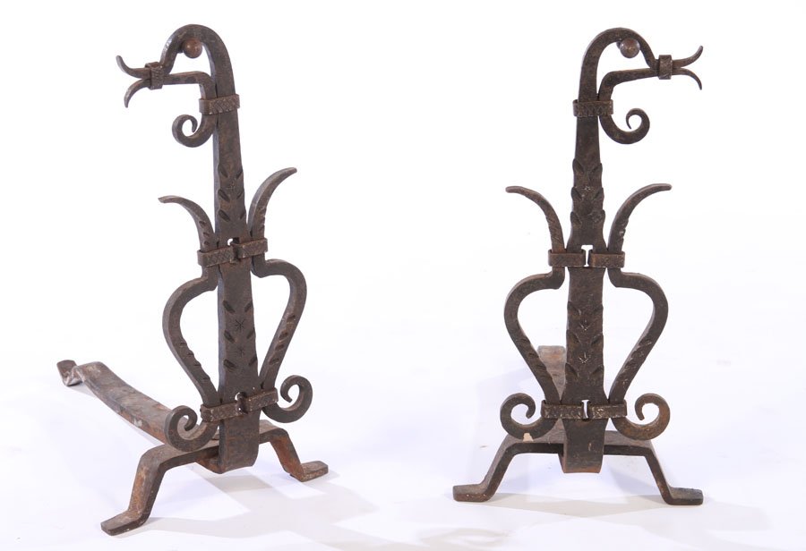 A PAIR OF 20TH CENTURY WROUGHT IRON ANDIRONS: A pair of twentieth century wrought iron andirons having incised and scroll decoration. Ht: 21" Wd: 10.5"