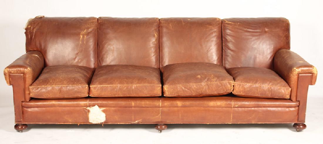 FRENCH LEATHER COUCH RAISED ON BUN FEET C.1950: A cool French leather upholstered couch having tailored arms and a loose cushion seat all raised on bun feet circa 1950. Ensuite Ht: 34" Wd: 100" Dpth: 37" Seat: 18"