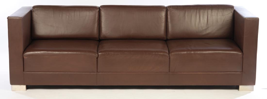 LEATHER UPHOLSTERED CUBIST FORM TAILORED COUCH: A leather upholstered Cubist form tailored two cushion couch. Ensuite Ht: 29.5" Wd: 95" Dpth: 32" Seat: 16"