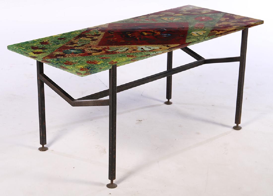 ITALIAN IRON GLASS COFFEE TABLE 1960: An Italian iron and glass coffee table with multicolored glass top circa 1960. Ht: 18" Width: 39" Depth: 16 1/2"