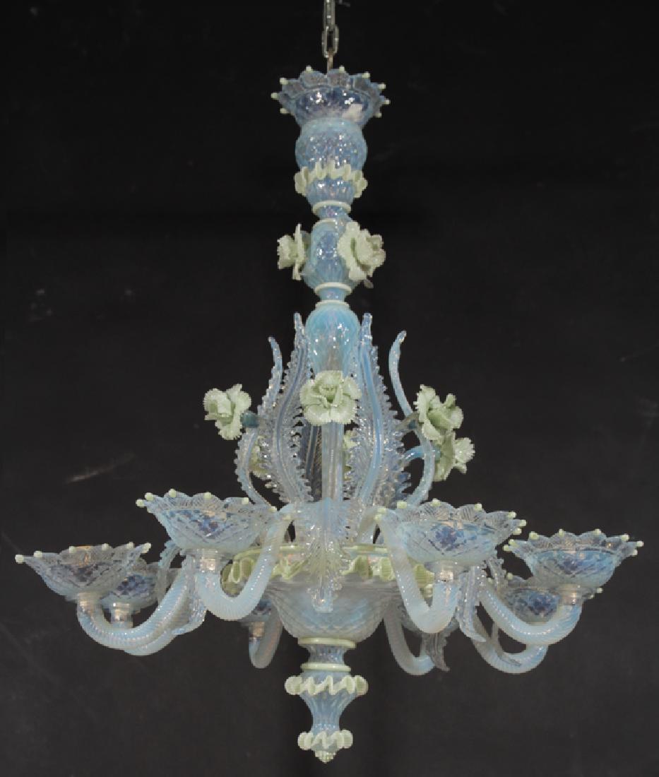 CELADON MURANO GLASS CHANDELIER CIRCA 1970: A light celadon Murano glass chandelier having center post with applied floral and leaf decoration circa 1970. All supporting a lower basket with eight arms. Ht: 32" Dia: 27"