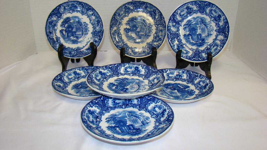 FLOW BLUE PETRUS ABBEY OF HOLLAND: FLOW BLUE ABBEY SAUCERS - 7 IN ALL - 6 IN DIAMETER - STAMPED ON BACK PETRUS REGOUTA CR MAASTRICHT ABBEY MADE IN HOLLAND - GOTHIC CATHEDRAL SCENE