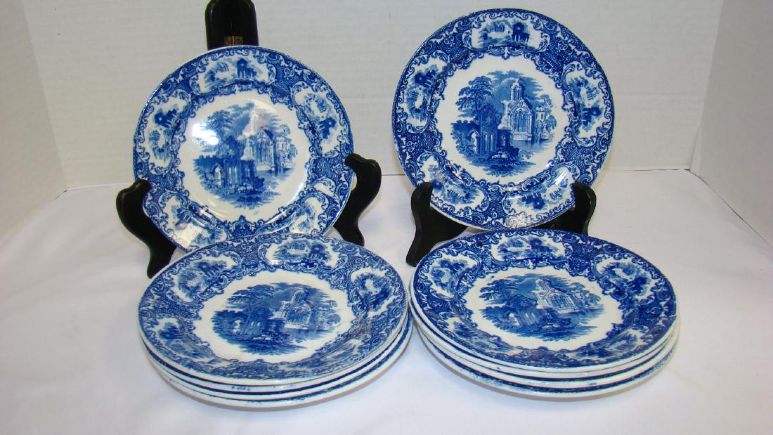 FLOW BLUE PETRUS REGOUTA CR MAASTRICHT ABBEY BREAD: FLOW BLUE PETRUS REGOUTA ABBEY BREAD PLATES - 6 & 1/2 IN DIAMETER - 10 IN ALL - STASMPED PETRUS REGOUTA CR MAASTRICHT ABBEY - VERY GOOD CONDITION - 1 PLATE HAS CRACK ON BOTTOM - NO CHIPS - MINOR FLAWS