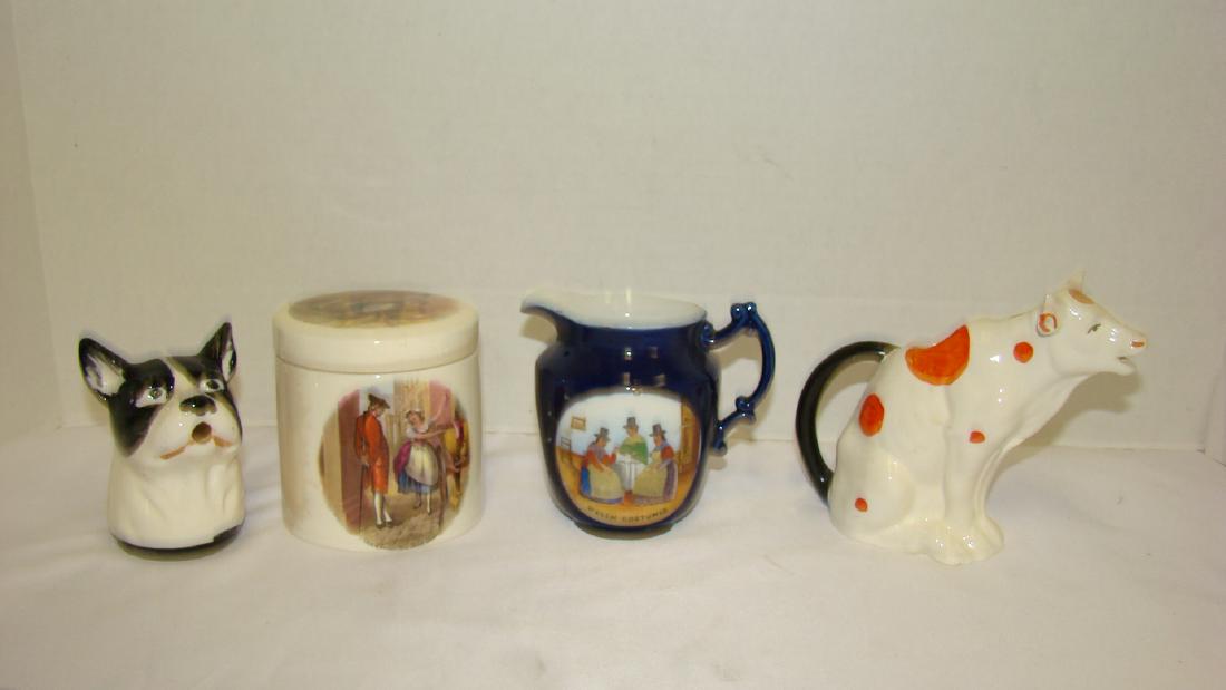 VINTAGE CREAMERS AND SMALL CANISTER: VINTAGE CREAMERS AND SMALL CANISTER - 1 CREAMER IN THE SHAPE OF A COW - 1 IN THE SHAPE OF A DOG - 1 BLUE PITCHER WITH 3 PEOPLE ON FRONT IN WELSH COSTUMES - AND 1 SMALL CANISTER WITH A FRENCH MAID AND