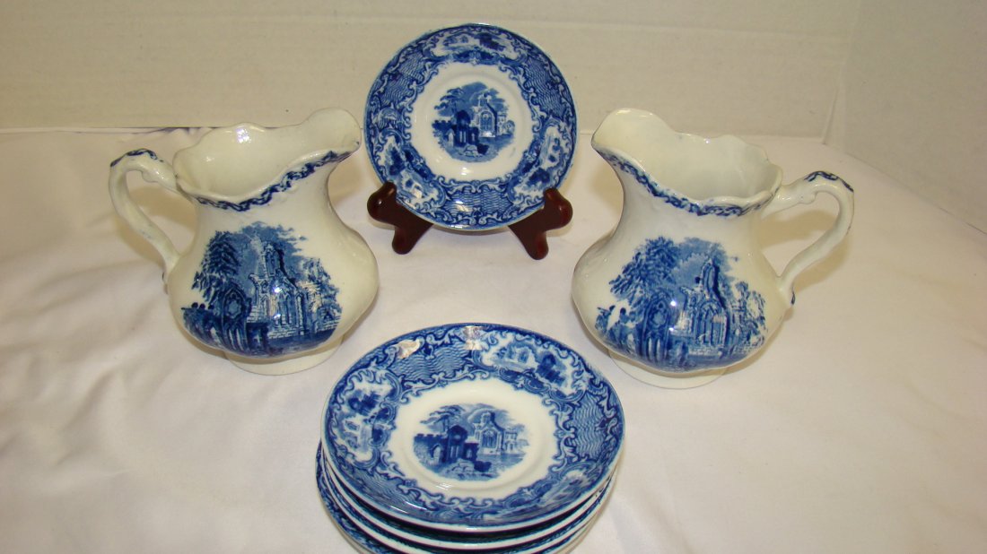 FLOW BLUE ABBEY OF ENGLAND SAUCERS - ABBEY OF HOLL: FLOW BLUE ABBEY OF ENGLAND SUACERS AND ABBEY OF HOLLAND CREAMERS - 5 SAUCERS ARE STAMPED ENGLAND IN A GOTHIC CATHEDRAL DESIGN - FEW FLAWS - NO CHIPS - 1 BREAD PLATE STAMPED ABBY ENGLAND - GOOD CONDITI