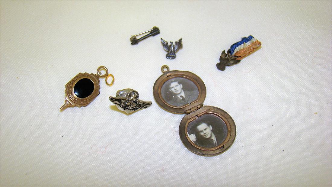 1859 TEACHERS COLLEGE PIN AND MINITURE WAR MEDALS: 1859 TEACHERS COLLEGE PIN WITH BLACK CENTER STONE AND GOLD TONED METAL - EAGLE PIN ON RED, WHITE, AND BLUE RIBBON - ARROW PIN - EAGLE PIN AND WING PIN - SMALL PHOTO LOCKET IN GOLD METAL WITH 2 PICTURE