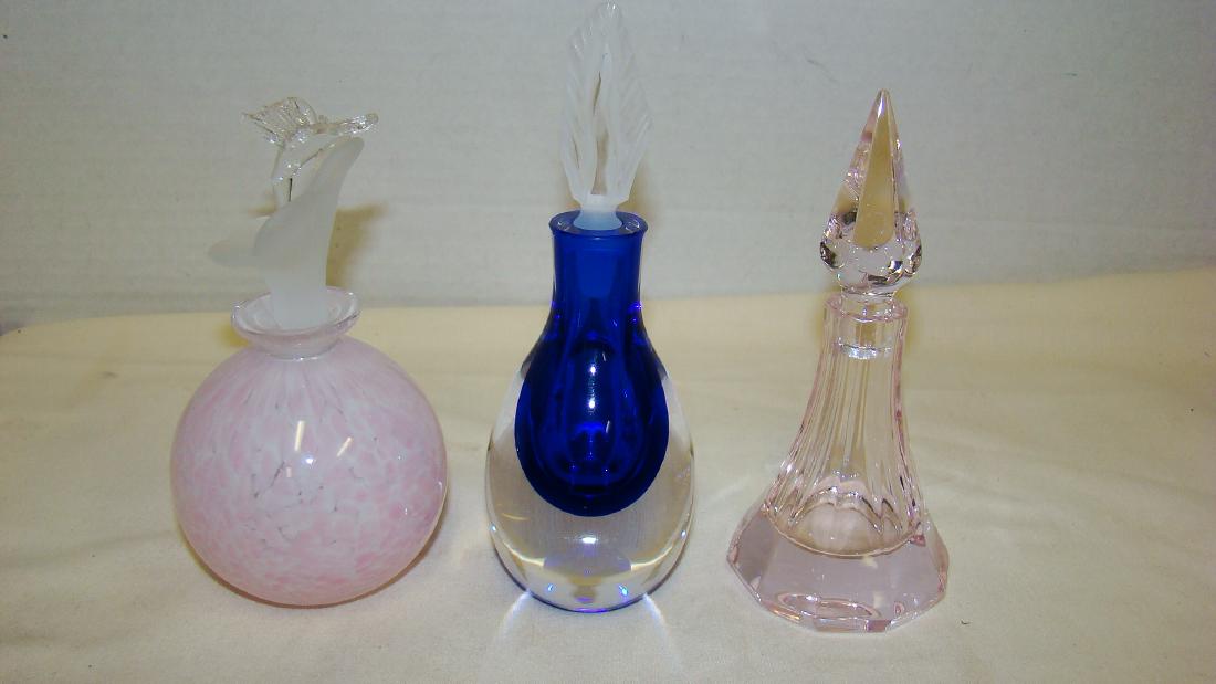 BEAUTIFUL VINTAGE PERFUME BOTTLES: BEAUTIFUL VINTAGE PERFUME BOTTLES - 1 IN A PINK AND WHITE COLOR WITH FLOWER AND HUMMINGBIRD STOPPER - 1 TEAR DROP STYLE IN CLEAR AND DEEP BLUE WITH A FLAME DESIGN STOPPER - 1 CUT GLASS WITH STOPPER IN