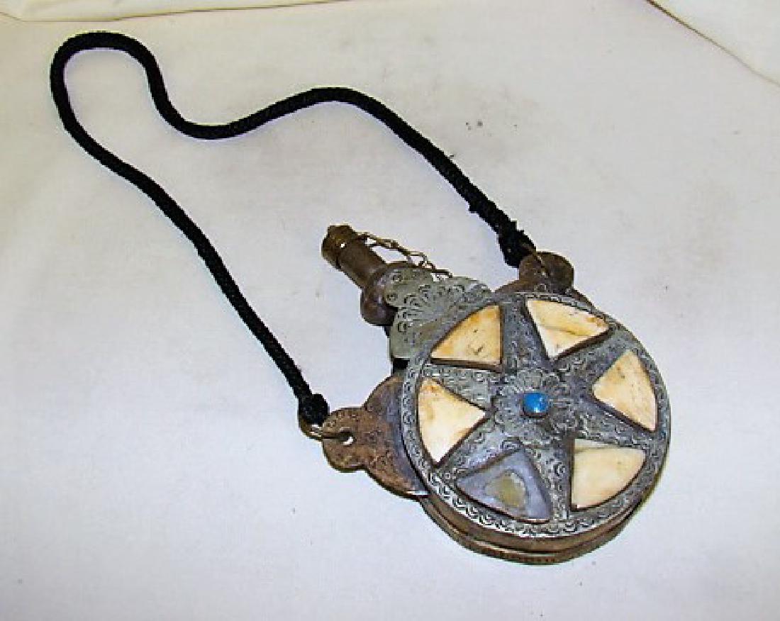 ANTIQUE BRASS GUN POWDER FLASK: ANTIQUE BRASS POWDER FLASK- USED FOR GUN POWDER- SHOWS AGE & WEAR- MISSING A TILE- BLACK ROPE IS A MODERN REPAIR.