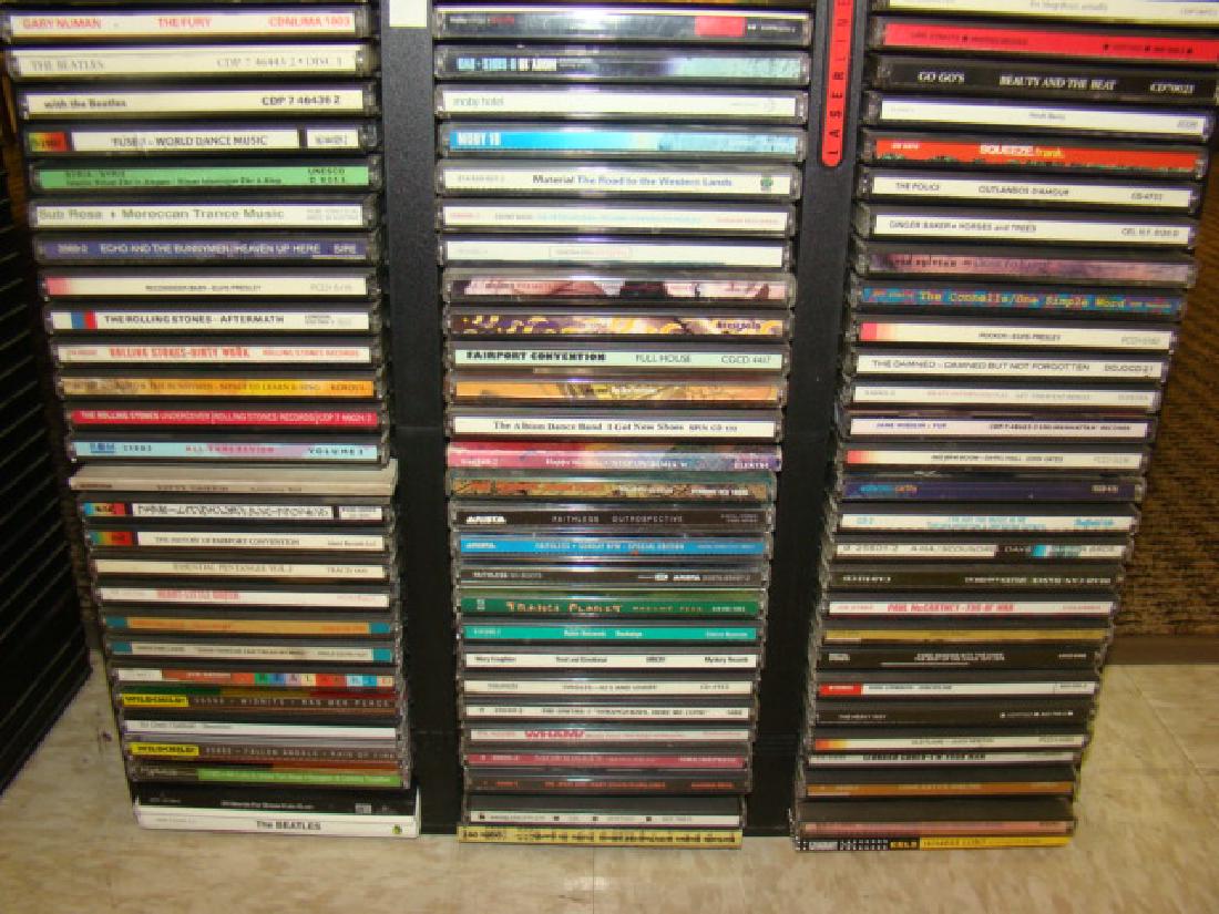 50+ MUSIC CDS: 50+ MUSIC CDS AND HOLDER ROLLING STONES SQUEEZE - THE GOGOS - MOBY - JANE WIEDLIN AND MANY MORE
