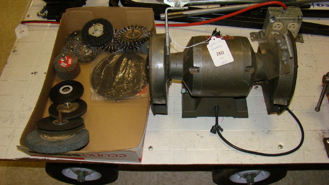 INDUSTRIAL BENCH GRINDER WITH BOX OF GRINDING WHEE: INDUSTRIAL BENCH GRINDER WITH A BOX OF VARIOUS GRINDING WHEELS-CORD HAS ELECTRICAL TAPE ON IT