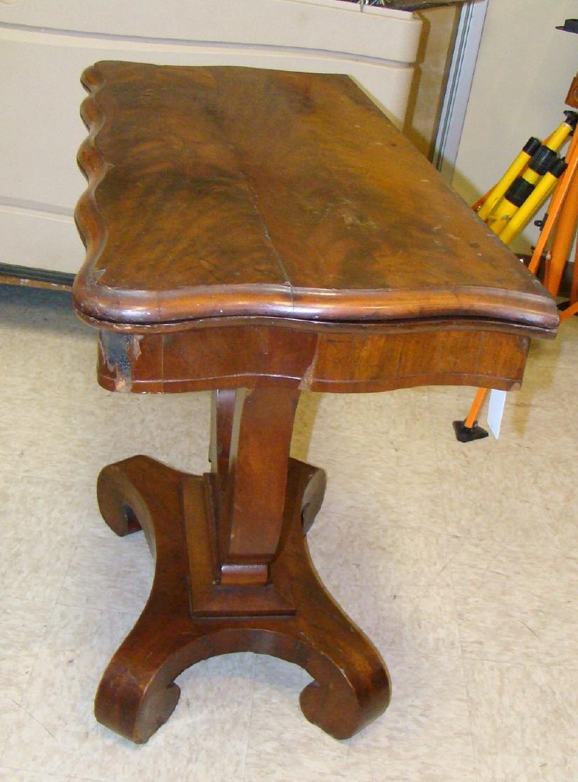 VINTAGE FOLDING HALLWAY TABLE: VINTAGE FOLDING HALLWAY TABLE - SCALLOPED EDGE 1/2 TABLE THAT UNFOLDS TO SMALL CARD TABLE SIZE. TOP ALSO TWISTS OPEN FOR STORAGE AREA - NEEDS SOME REPAIR