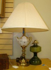 TABLE LAMP AND OIL LAMP: TABLE LAMP AND OIL LAMP - TABLE LAMP IS A TEA POT WITH FLOWERS AND GOLD TRIM - WITH BRASS BASE (DAMAGED) WITH SHADE AND IS SINGLE LIGHT BULB, GREEN GLASS OIL LAMP - BASE ONLY - APPEARS TO HAVE NEW WIC