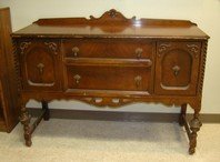 BUFFET HUTCH/CABINET: BUFFET HUTCH/CABINET - CARVED - TWO DRAWERS AND TWO CABINETS - HAS ALL METAL HARDWARE - ONE OF THE CABINET DOOR HINGE IS BROKEN - THE SUPPORT BAR UNDERNEATH IS MISSING - SHOWS ITS AGE