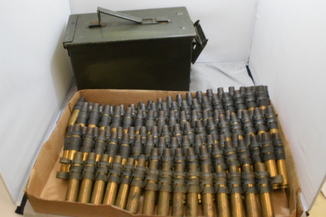 BOX WITH 4 STRIPS OF EMPTY .50 CAL CASINGS AND A M: BOX WITH 4 STRIPS OF EMPTY .50 CAL CASINGS AND A MILITARY GREEN AMMO BOX