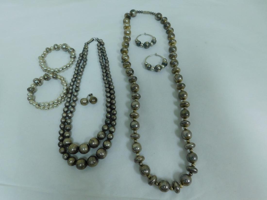 SILVER JEWELRY: SILVER JEWELRY - 2 SILVER COLORED/POSSIBLE SILVER BEADED NECKLACES - 1 MARKED BUT HARD TO DISTINGUISH WORDS - 2 SILVER BEADED BRACELETS MARKED 925 & 2 PIERCED EARRINGS UNMARKED