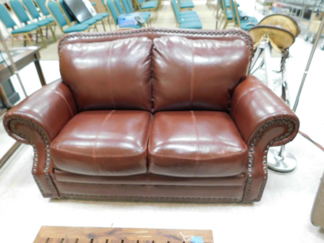 LEATHER LOVESEAT: LEATHER LOVESEAT - DEEP BURGUNDY COLOR - LOTS OF METAL STUDDING & DESIGN - MADE BY DIAMOND SOFA - APPEARS IN GREAT CONDITION