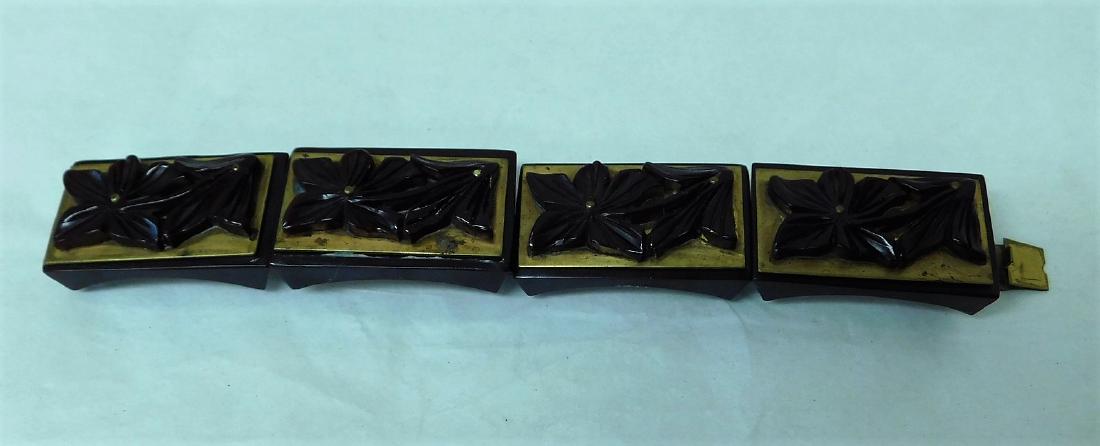 CARVED CHOCOLATE BAKELITE BRACELET: CARVED CHOCOLATE BAKELITE BRACELET - 4 SECTIONED LAYERED BAKELITE BRACELET - CHOCOLATE BROWN COLORING WITH METAL - CHOCOLATE BARS ON BOTTOM - LAYERED WITH A BRASS COLORED METAL AND TOPPED WITH HIGHLY 