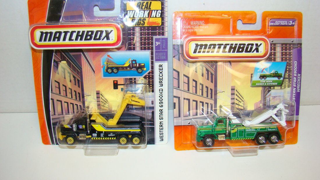2008 & 2009 MATCHBOX REAL WORKING RIGS-NIP: 2008 MATCHBOX REAL WORKING RIGS - WESTERN STAR 6900XD WRECKER - NIP - YELLOW AND BLACK AND A 2009 WESTERN STAR 6900XD WRECKER - NIP - GREEN