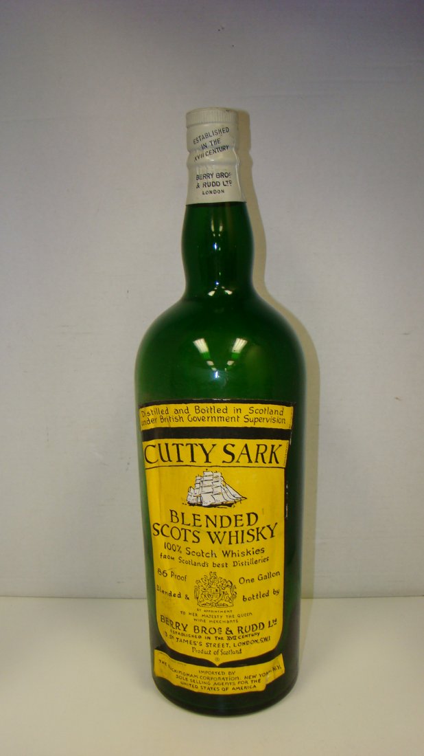 VTG GREEN GLASS CUTTY SARK DISPLAY BOTTLE: VINTAGE GREEN GLASS 19'' CUTTY SARK WHISKEY DISPLAY BOTTLE - YELLOW AND BLACK LABEL - BACK LABEL READS ''NOT GENUINE - FOR DISPLAY ONLY - FRONT LABEL HAS WRINKLED ON ONE SIDE AND IS COMING AWAY FROM T