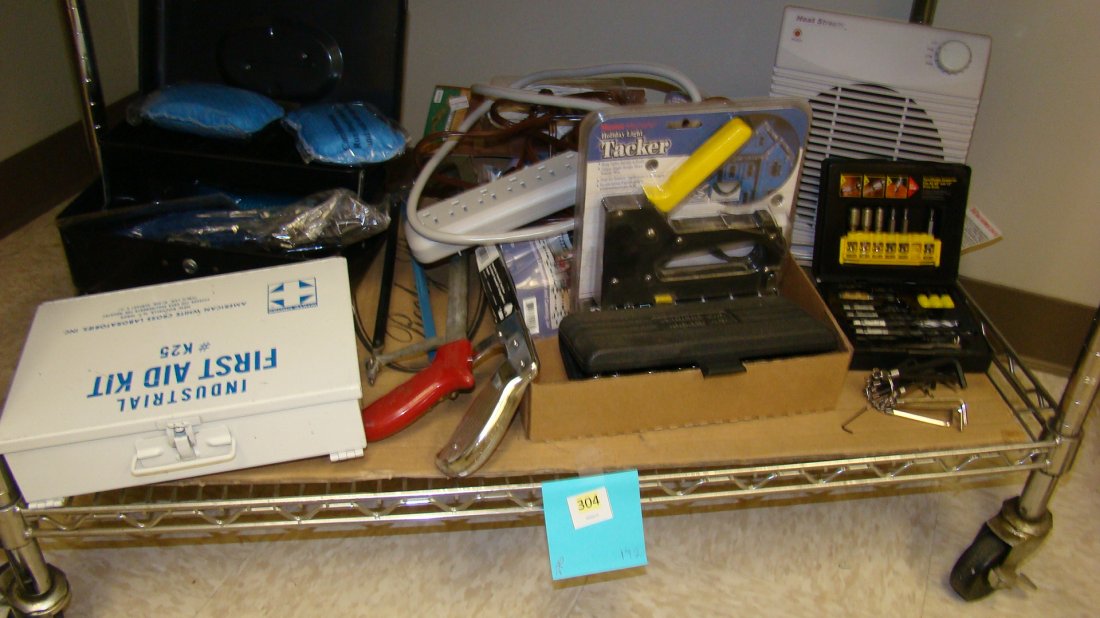 SHELF-VARIOUS GARAGE ITEMS: SHELF LOT OF MISCELLANEOUS GARAGE ITEMS - SMALL TOOL BOX - SURGE PROTECTOR BAR - MASTER MECHANIC TACKER - STANLEY FAST CHANGE CONNECTOR ELECTRIC DRILL BITS - HAND SAWS - FIRST AID KIT - SMALL HEATER A