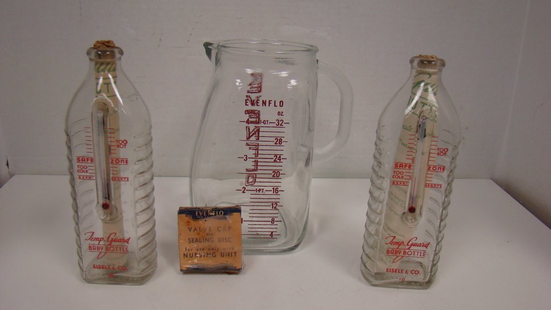 NOS TEMP-GUARD BABY BOTTLE-EVENFLO PITCHER: 2 NEW OLD STOCK TEMP-GUARD GLASS BABY BOTTLES WITH THERMOMETER AND ORIGINAL INSTRUCTIONS - 7'' EVENFLO 4 CUP GLASS PITCHER AND A BOX OF EVENFLO VALVE CAP AND SEAL DISC FOR NURSING UNIT - SEAL IS START