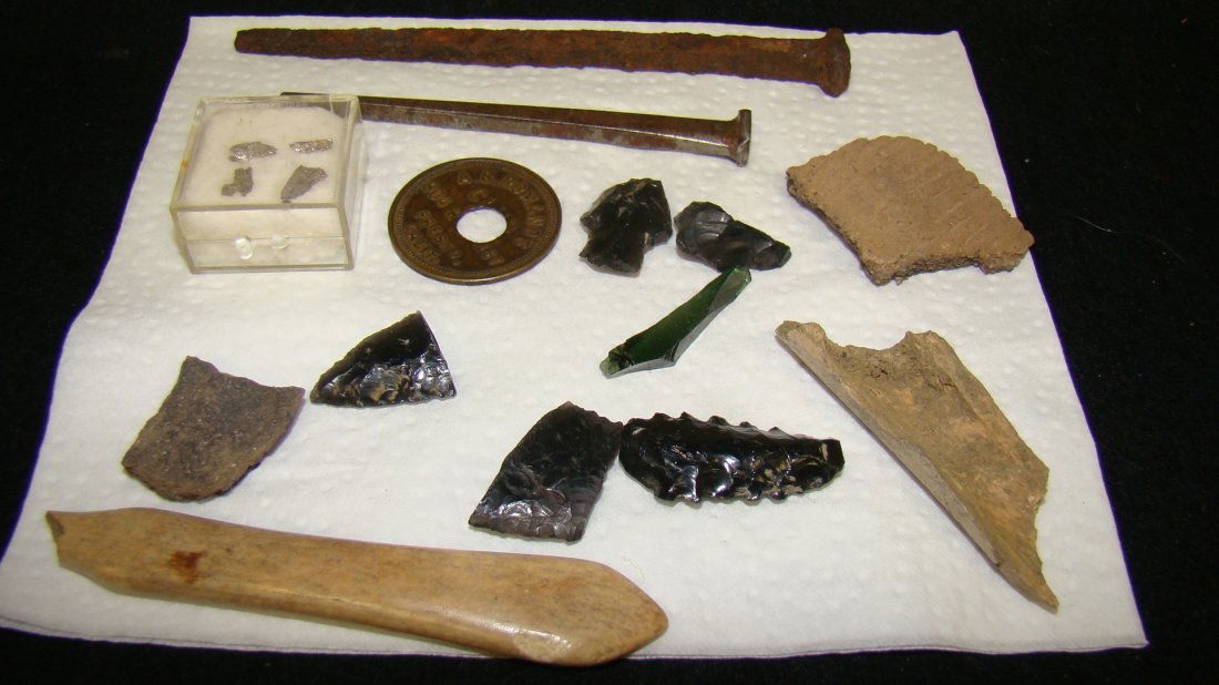 OBSIDIAN ARROWHEAD-SILVER FLAKES & MORE: VARIOUS PIECES OF OBSIDIAN TO MAKE ARROWHEADS - 3 PARTS OF ARROWHEADS - 4 SMALL WHAT LOOK LIKE SILVER FLAKES - 2 OLD LONG NAILS - DRINK TOKEN FOR THE A.B. ROMANOS CLUB IN FRESNO CALIF AND MORE