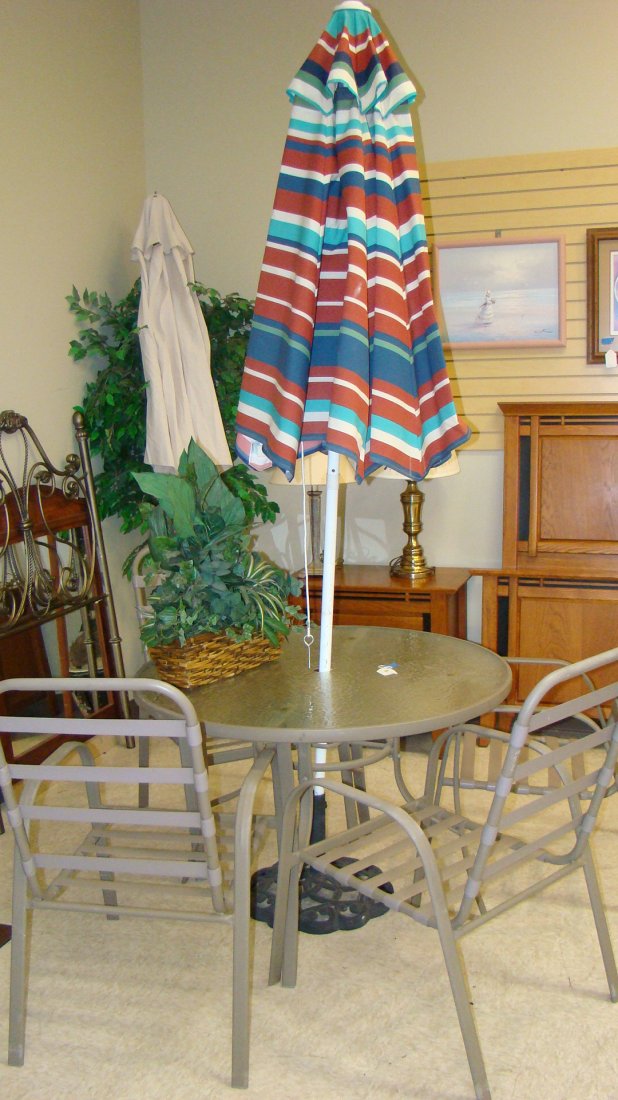 ROUND GLASS TOP PATIO TABLE SET: ROUND GLASS TOP PATIO TABLE - UMBRELLA WITH STAND AND 4 CHAIRS - TAN COLOR WITH CLEAR GLASS - TAN COLOR PATIO ARM CHAIRS - RED, WHITE GREEN AND BLUE STRIPED UMBRELLA WITH WROUGHT IRON STAND UMBRELLA S