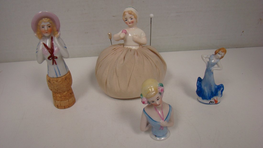 VTG GERMAN PIN CUSHION DOLL & 3 PORCELAIN GIRLS: VINTAGE GERMAN PIN CUSHION DUTCH GIRL DOLL - 5'' - 5'' PORCELAIN AND CORK FIGURAL BOTTLE STOPPER - 3'' HAND PAINTED PORCELAIN HALF DOLL AND A 3'' HAND PAINTED PORCELAIN FIGURINE