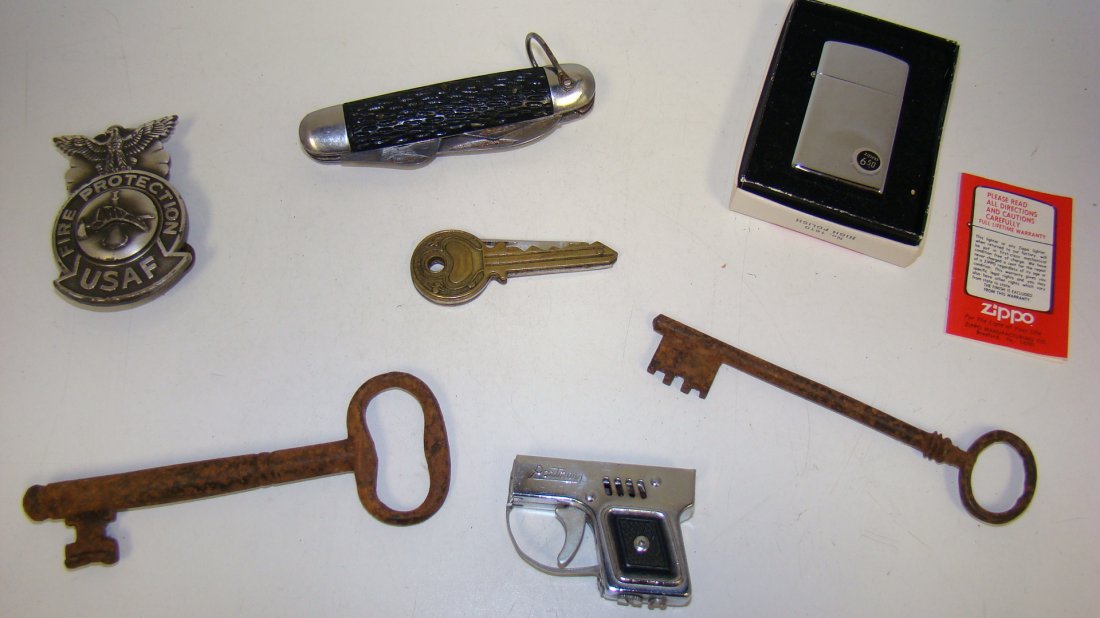 7 VARIOUS COLLECTIBLES- USAF BADGE: 7 VARIOUS FUN COLLECTIBLES - USAF FIRE PROTECTION HAT BADGE - VINTAGE SABRE SURVIVAL POCKET KNIFE - ZIPPO LIGHTER IN ORIGINAL BOX - SMALL PISTOL SHAPED CIGARETTE LIGHTER - FUN KEY SHAPED POCKET KNIFE