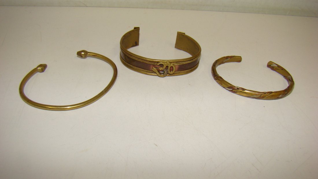 3 VARIOUS VTG BRASS CUFF BRACELETS: 3 VARIOUS VINTAGE BRASS CUFF BRACELETS - HALF INCH COPPER COLOR CENTER BRASS CUFF BRACELET - APPLIED 30 FIGURE ON UPPER CENTER - BRASS AND COPPER BRAIDED CUFF BRACELET AND A SIMPLE BRASS CUFF BRACELET